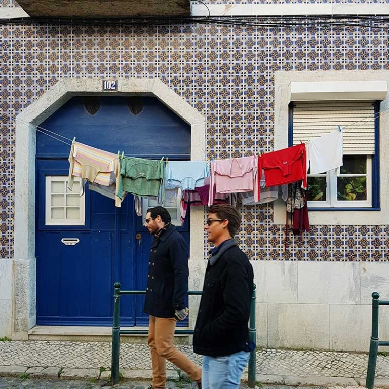 Washing hanging outside a tiled building in Lisbon, Portugal