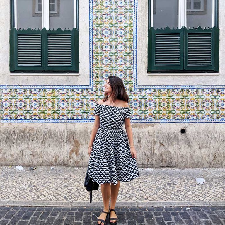 Daniela in front of a tiled building, Lisbon, Portugal