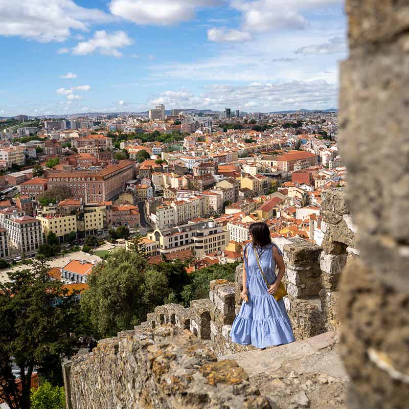 Standing on the rampants of Sao Jorge castle in Lisbon, Portugal