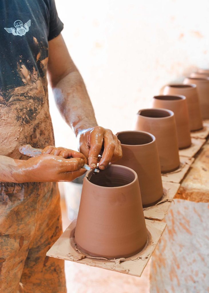 Someone making Portuguese pottery in Corval, Portugal's terracotta pottery village