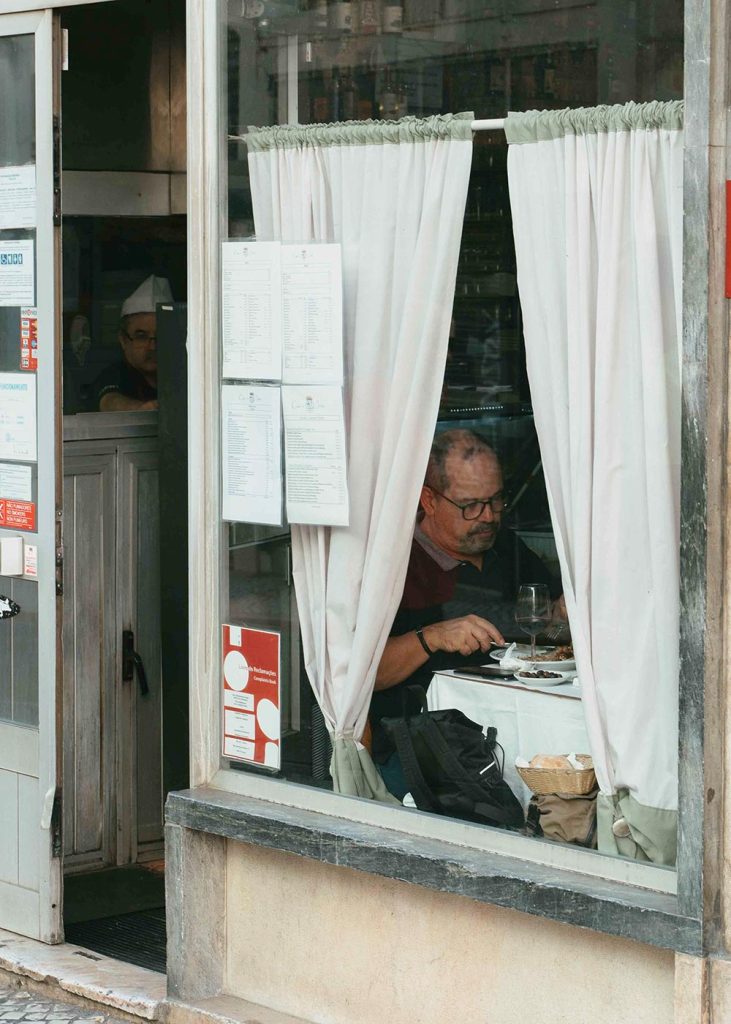 A man eating inside Casa da India tasca