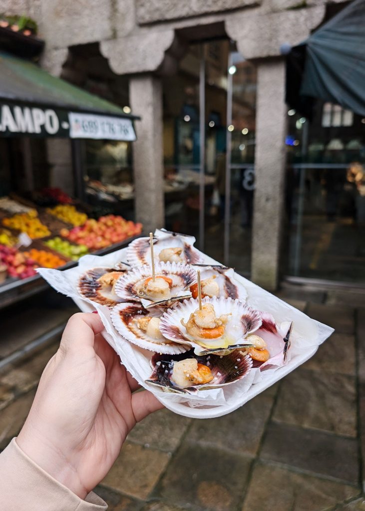 Eating fresh scallops at the famous Abastos Markets in Galicia, Spain